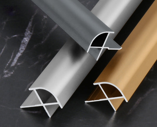 Aluminum curved edge trim profiles in black, silver, and gold finishes for wall panel edges, providing smooth corner protection and modern architectural panel transitions
