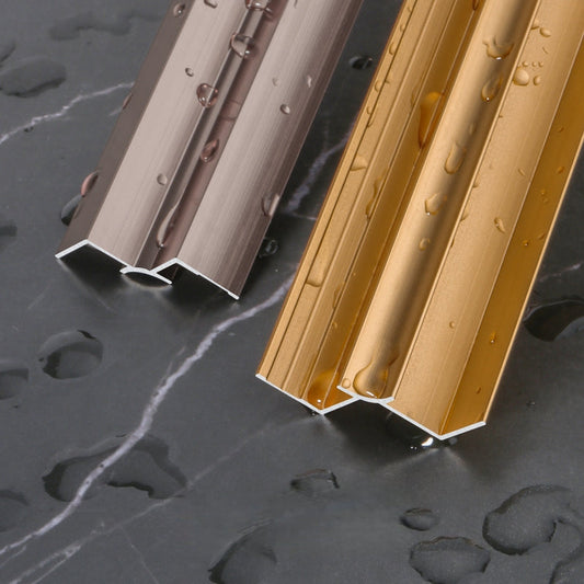 Water-resistant aluminum wall panel trim profiles in gold and bronze finishes, designed for durable edge protection and clean panel transitions in modern interior installations