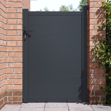 Black composite fence gate with horizontal privacy panels installed between brick pillars