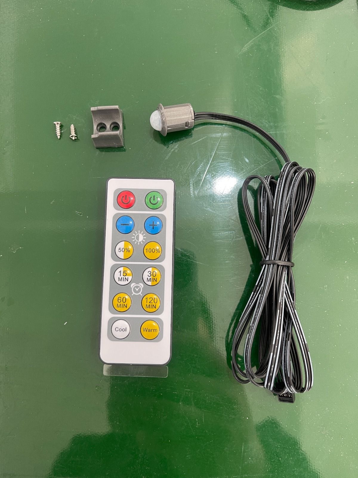 Smart LED light remote control with brightness, timer, and color temperature settings, including mounting clips, screws, and connection cable for LED strip lighting systems
