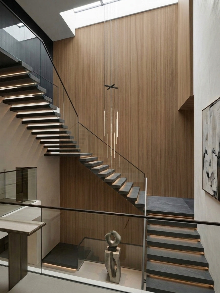 Floor-to-ceiling ash wood veneer panels installed along a contemporary floating staircase