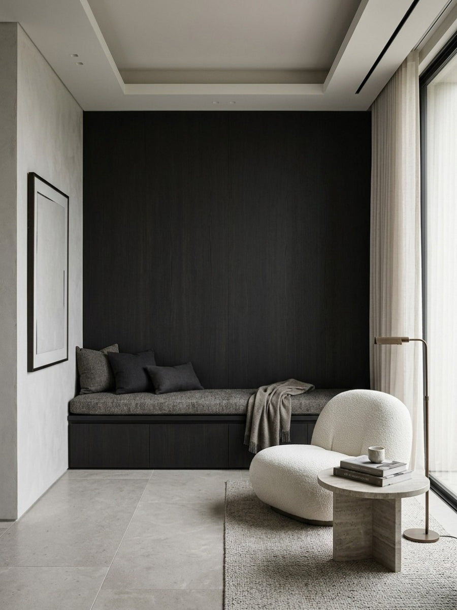 Blackwood veneer wall panels forming a dark accent wall above built-in seating in a minimalist lounge