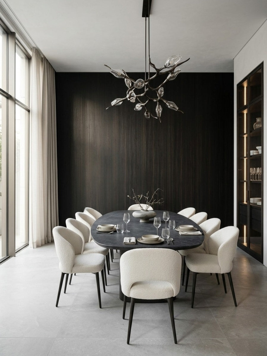 Blackwood veneer panels creating a dark feature wall behind a modern oval dining table