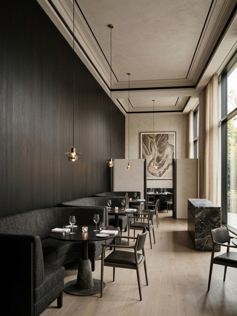 Dark wood-grain blackwood veneer panels lining a restaurant wall with banquette seating and pendant lights