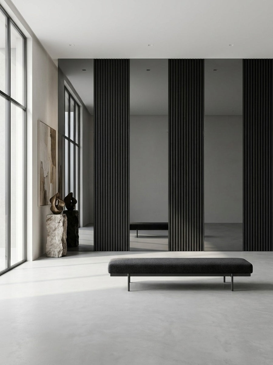 Gray mirror wood veneer panels installed between black fluted wall sections in a minimalist interior with a low bench