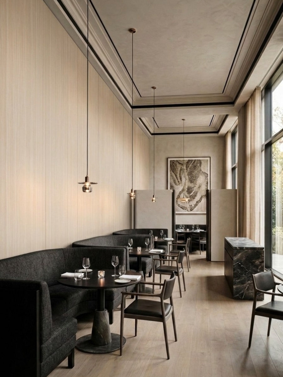 Restaurant dining area lined with pale Nordic birch wood veneer panels and pendant lights